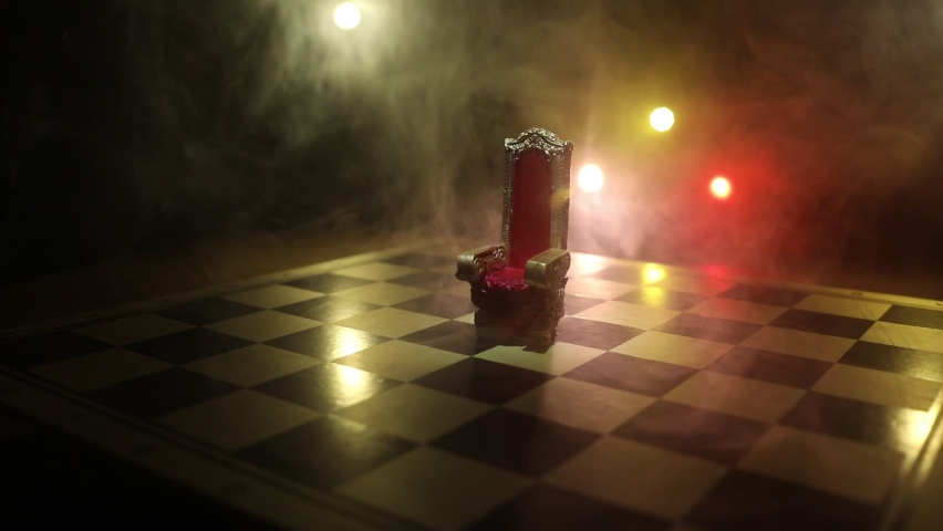 Red royal chair miniature on wooden table. Medieval Throne on chessboard. Chess board game concept of business ideas and competition and strategy ideas concept. Selective focus | Shutterstock HD Video #1067524010
