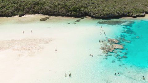 Aerial footage of Natural Pool Piscine Naturelle on Isle of Pines in New Caledonia.Tourists snorkeling in the clear blue water. Pacific ocean and Ile des pins tourism. High quality 4k footage