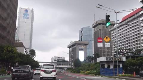 Jakarta, traffic is flow, cloudy after the rain, Thamrin street around the National Monument (Monas). after lockdown. (1-2021)
