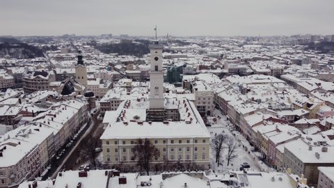 Aerial view of the snow-covered city of Lviv, Ukraine. Panorama of the popular central part of the old European city of Lviv. Fabulous view of the snow-covered old town. Flight over roofs, streets