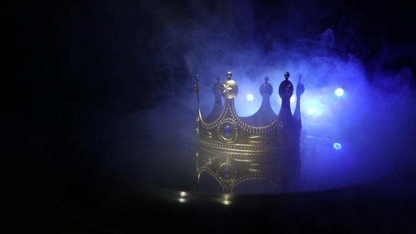 Beautiful king crown over metallic surface. vintage filtered. fantasy medieval period. Selective focus. Colorful backlight | Shutterstock HD Video #1067537552