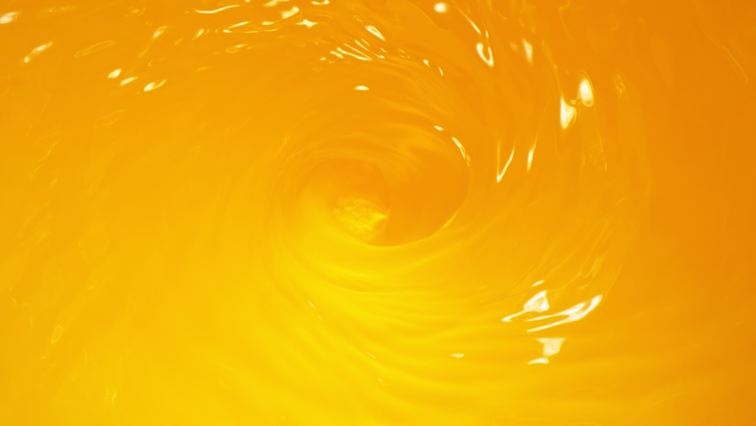 Super Slow Motion Shot of Pouring Fresh Orange Juice into Whirl at 1000 fps. Royalty-Free Stock Footage #1067543009