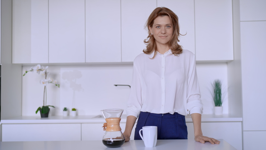 businesswoman posing looking camera cheerful smiling on the kitchen slow motion