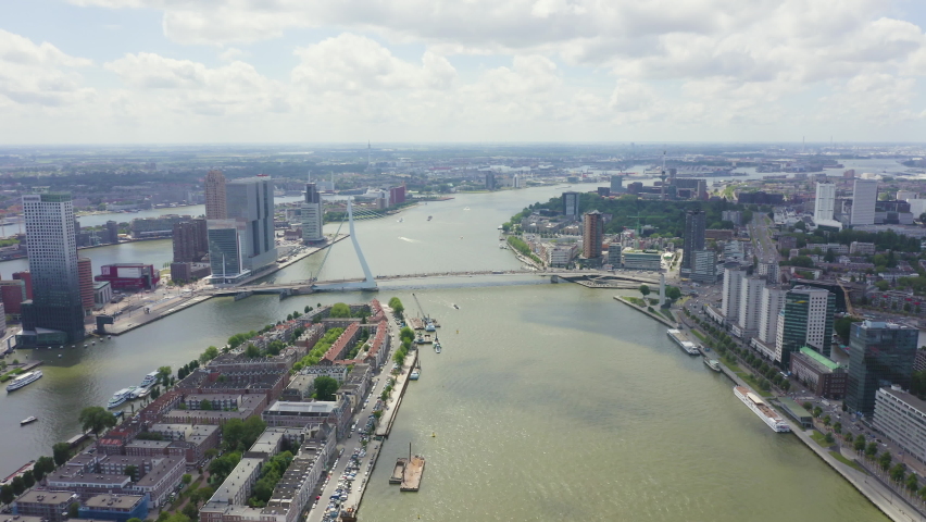 Inscription on video. Rotterdam, Netherlands. Norderayland Island ( North Island ) and Erasmus Bridge ( Erasmusbrug ) over the Nieuwe Maas River. Glitch effect text, Aerial View, Point of interest