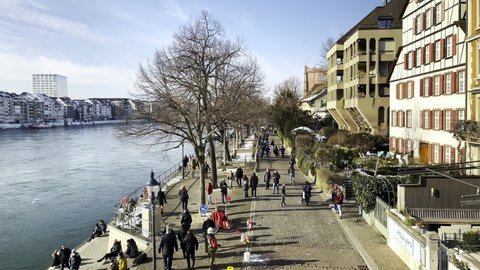 Basel, Switzerland - February 14, 2021: Promenade on the bank along the Rhine River in Basel