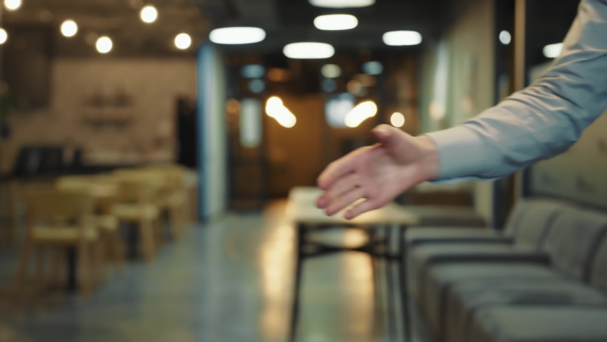 Close up of two businessmen greeting or shaking hands as a sign of successful completion of meeting and negotiations in the office. | Shutterstock HD Video #1067558480