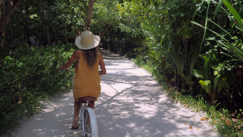 Point of view of couple cycling on tropical island around luxury resort in The Maldives  | Shutterstock HD Video #1067560106