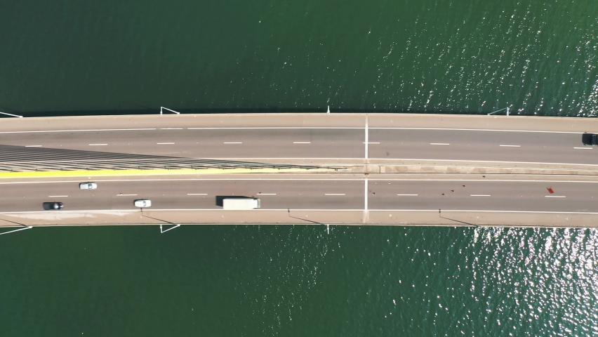 Aerial top down view of the traffic bridge above the ocean