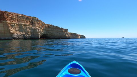 Kayaking at sea on sunny day, Algarve. Kayaker POV