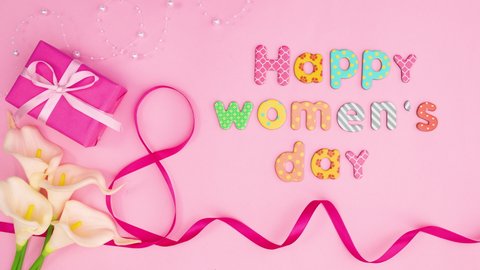 6k  Happy women's day text write on pink theme with flowers and gift. Stop motion