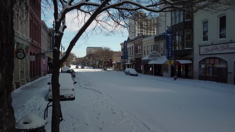 Austin, Texas - February 15, 2021: Snow covers a frozen 6th street in the downtown nightlife district