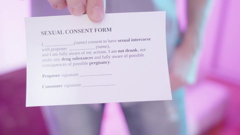 Sexual male person torso put out the consent form card to sign 4K