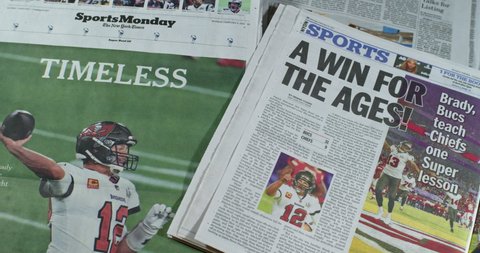 New York, New York  United States - February 7,  2021: Newspaper Coverage of Tom Brady winning Super Bowl 55 as a member of the Tampa Bay Buccaneers. Headlines: A WIN FOR THE AGES. TIMELESS!