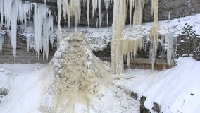 Aerial 4k footage of a beautiful frozen waterfall in winter