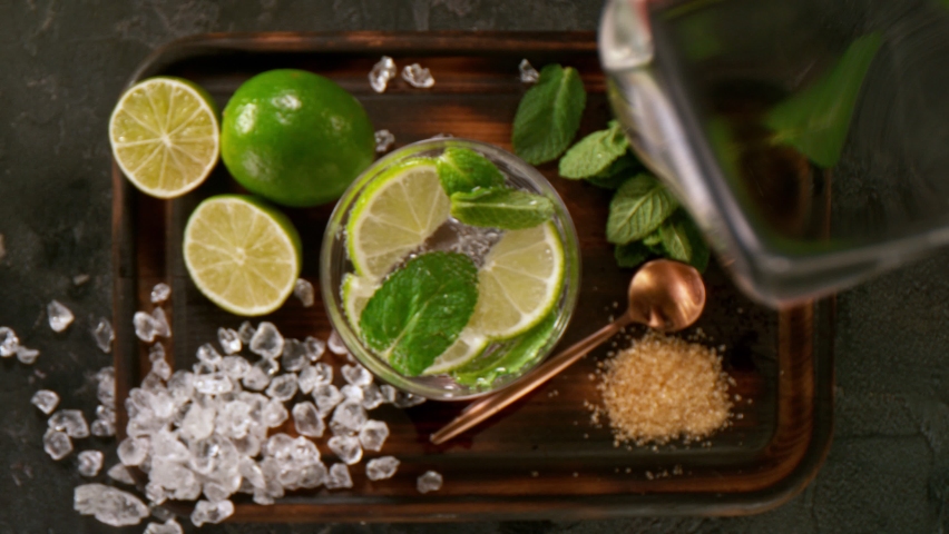Camera Follows Ice cubes Falling into Glass of Fresh Mojito Cocktail. Super Slow Motion filmed on High Speed Cinema Camera. | Shutterstock HD Video #1067599349