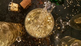 Camera Movement, Super Slow Motion Detail Shot of Pouring Champagne from Bottle on Black Stone Background at 1000fps. - Powered by Shutterstock - Get 15% off with code: PIKWIZARD15