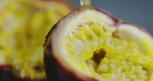 Close up 4k video of tropical juice flowing on natural exotic passion fruit, vegan healthy eating with vitamins