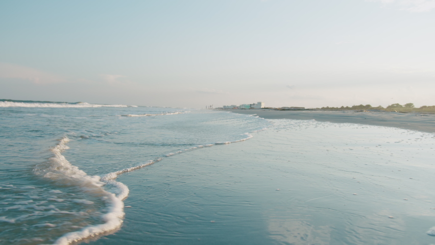 Charleston South Carolina Beach Houses at Sunset as Waves Wash over Sand