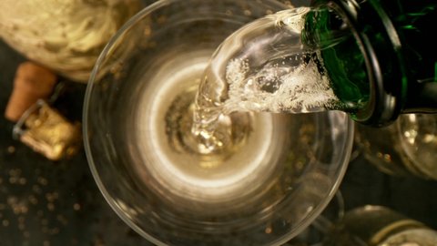 Super slow motion of pouring champagne into glass with camera motion. Filmed on high speed cinema camera.