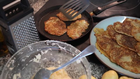 Frying potatoes pancakes during cooking in frying pan, belarussian cuisine