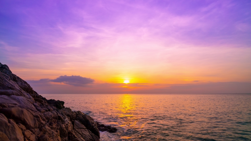 Timelapse colorful pastel clouds in sunset time Beautiful light of nature Amazing colors of the setting sun Majestic clouds flowing in sunset sky Evening dark clouds with rocks in the foreground | Shutterstock HD Video #1067610734