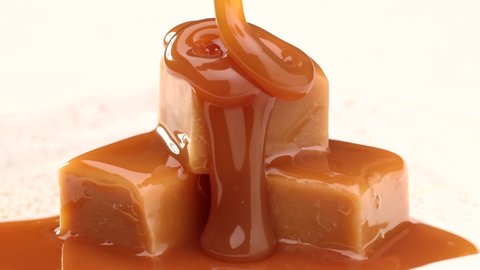 melted caramel sauce flowing on caramel candies close up