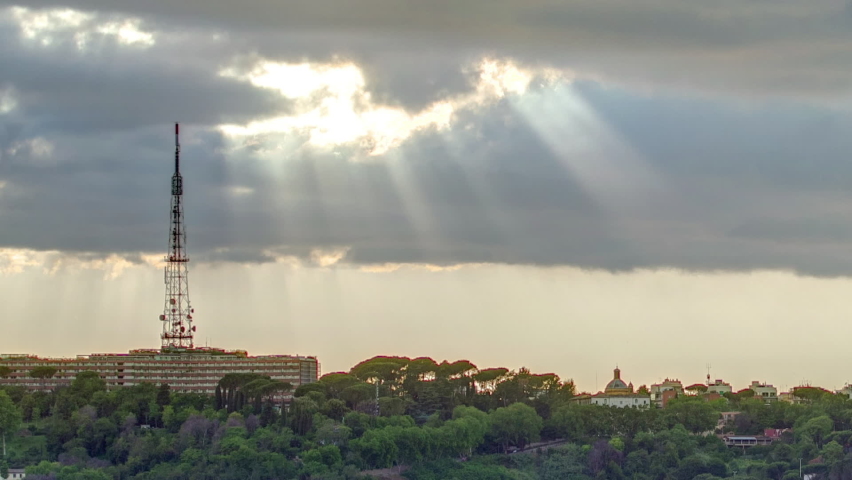Cityscape of Rome timelapse under a dramatic sky as seen from the Pincio hill, Italy. Top view with rays of sun