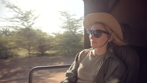 Wild Nature Of Search Lions And Giraffe Serengeti Or Ngorongoro.Woman On Africa River Safari Adventure.Safari Trip On Tanzania Selous.Tourist In Hat On African Safari Adventure On Holiday Vacation.