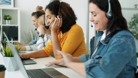 Multiracial group of call center employees talking with headset typing with laptop and taking notes working in office together. Job and profession concept. - Powered by Shutterstock - Get 15% off with code: PIKWIZARD15
