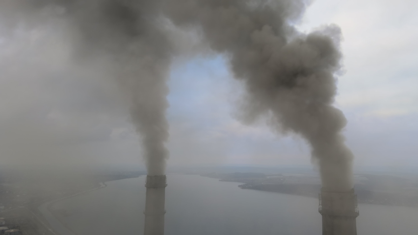 Aerial view of coal power plant high pipes with black smoke moving up polluting atmosphere. | Shutterstock HD Video #1067625614