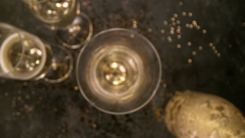 Camera Movement, Super Slow Motion Detail Shot of Pouring Champagne from Bottle on Black Stone Background  