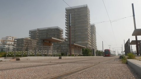 Modern tramway rides on rails among the modern building in the morning day in Casablanca, MOROCCO
