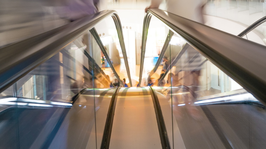 Fast moving people on escalator. Modern shopping mall urban architecture concept Royalty-Free Stock Footage #1067636336