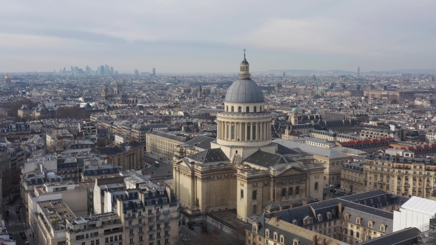 France, Paris, Pantheon church and Place of Estrapade with Tour Eiffel tower and La Défense in the background, long left to right drone aerial view. Royalty-Free Stock Footage #1067638667