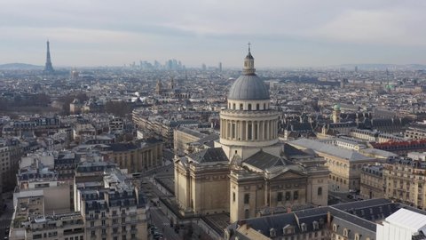 France, Paris, Pantheon church and Place of Estrapade with Tour Eiffel tower and La Défense in the background, long left to right drone aerial view.