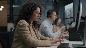 Call center and helpful customer service. Use desktop pc at computer table and phone line at modern co-working. Diverse group of workers talks on sale hotline. Busy seller at agency office close-up - Powered by Shutterstock - Get 15% off with code: PIKWIZARD15