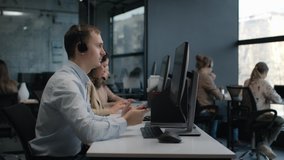 Call center and helpful customer service 24-7. Use desktop pc at computer table and phone line at modern co-working. Diverse group of workers talks on sale hotline. Busy seller at agency office indoor - Powered by Shutterstock - Get 15% off with code: PIKWIZARD15