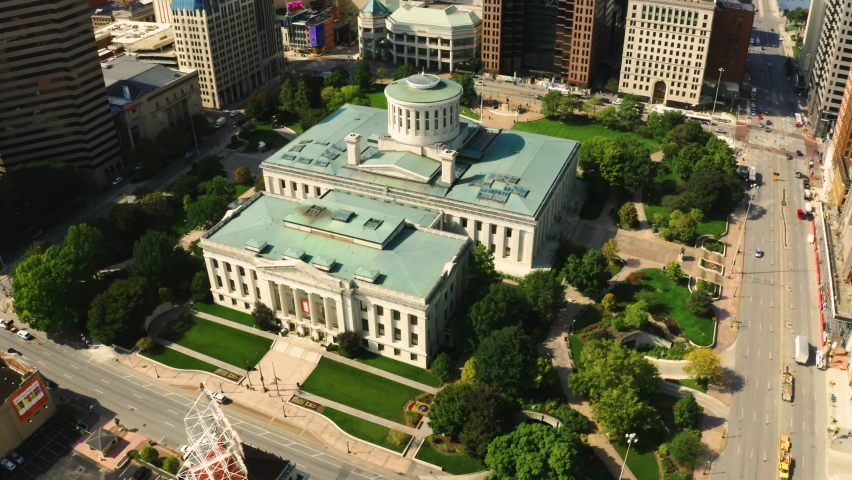 Aerial revealing shot of the Ohio State House and Columbus skyline with slow rotation in front of the Capitol