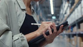 Attractive young Asia businesswoman manager looking for goods using digital tablet checking inventory levels standing in retail shopping center. Distribution, Logistics, Packages ready for shipment. - Powered by Shutterstock - Get 15% off with code: PIKWIZARD15