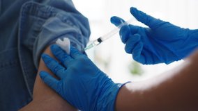 Young Asia lady nurse giving Covid-19 or flu antivirus vaccine shot to senior male patient wear face mask protection from virus disease at health clinic or hospital office. Vaccination concept. - Powered by Shutterstock - Get 15% off with code: PIKWIZARD15