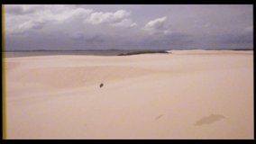 Desert and dune s in vintage VHS footage with wind and sand. Summer with wind in old footage with grain and noise