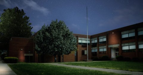 A night establishing shot of a typical small town two-story red brick school building. Room lights turn on and off. Day and winter versions available. Manipulated scene. Day: 1029018890