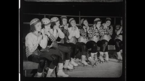 1940s Chicago, IL. Roller Derby Girls in Leather Helmets Roller Skate Around a Roller Rink. 4K Overscan of Vintage Archival 16mm Film Print