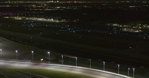 Daytona Beach Florida Aerial v3 panning reveal of the international speedway by night - Shot with Inspire 2, X7 camera - March 2020