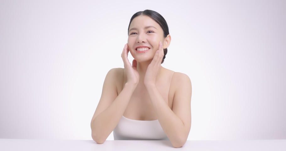 Close Up Of Young Beautiful Asian Woman Massages Her Face Gently With Fingertips. | Shutterstock HD Video #1067684588