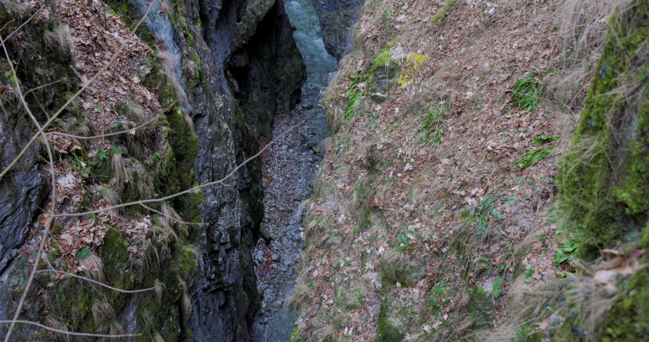 The winter river flows on the canyon of the waterfall on the Oltet Gorges in the Carpathian Mountains Romania .