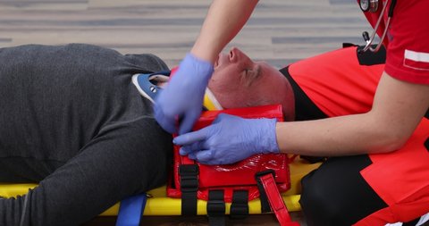 Patient on stretcher in EMS training emergency rescue situation, Paramedic Training. CPR medical training lies on a stretcher