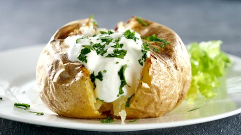 baked potato with cream and herbs