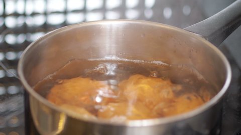 Eggs boiling in the pot in 4k slow motion 60fps
