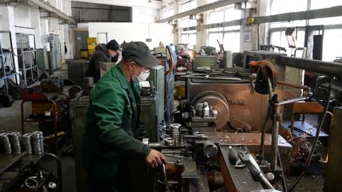 VINNYTSIA, UKRAINE - FEBRUARY 16, 2021: Old factory and outdated equipment. Fuel pump manufacturing. Locksmiths and turners at the old factory.  